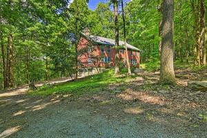 a house in the middle of a forest at Bear's Eye View - Mountain Retreat w/ Hot Tub! in Acme