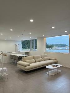 a large living room with a couch and a table at OOU SPACE in Geoje