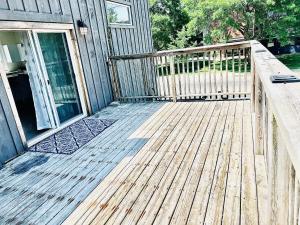 a wooden deck with a wooden railing on a house at LaVida Exclusive Guest House(Rm#4) in London