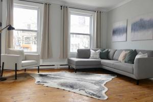 a living room with a couch and two chairs at Historic Downtown Apt #2 in Halifax