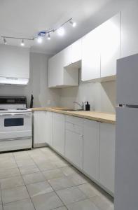 a white kitchen with white cabinets and appliances at Historic Downtown Apt #2 in Halifax