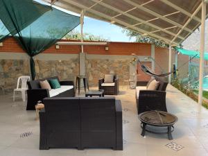 an outdoor patio with couches and a hammock at Hospedaje Villa Justina in Santa Eulalia