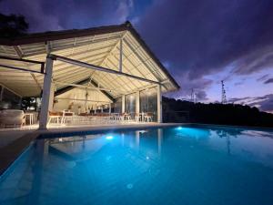 a large swimming pool with a pavilion at night at Tantawan sea view residence 山海居 in Salad Beach