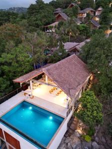 an aerial view of a house with a swimming pool at Tantawan sea view residence 山海居 in Salad Beach