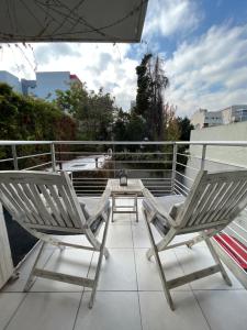 two chairs and a table on a balcony at Departamento Premium en Belgrano con Pileta in Buenos Aires
