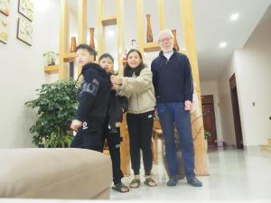 a group of people standing in a living room at GiaBinh Homestay in Cao Bằng