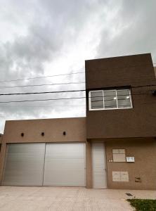 a building with two garage doors in front of it at TERRA - Departamento 1 in Esperanza