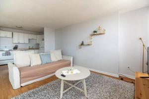 a living room with a couch and a table at Bright DT Apt #7A, Amazing View in Halifax