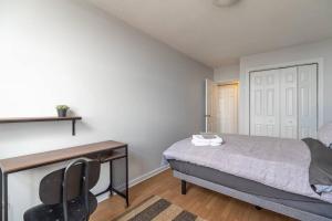 a bedroom with a bed and a desk with a chair at Bright DT Apt #7A, Amazing View in Halifax