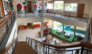 an overhead view of a house with a swimming pool at Kuta Suci Guesthouse in Kuta