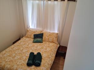 a bed with two pairs of shoes sitting on it at Pillar to Coast in Pillar Valley