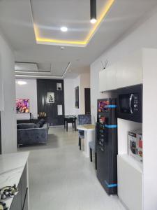 a kitchen and living room with a couch and a table at Wonder court 2 lekki phase1 in Lekki