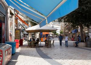 a street with tables and chairs and an umbrella at Ben Hillel Boutique Hotel in Jerusalem