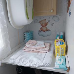 a baby crib with a teddy bear on a cloud at warden springs caravan park MS16 Thornhill road, Eastchurch,ME124HF in Sheerness