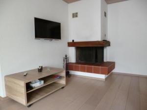 a living room with a fireplace and a flat screen tv at Chesa Blais , 1 Stock - b48820 in Zuoz