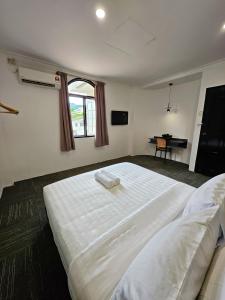 a bedroom with a large white bed with a window at Luna Hotel by Moonknight in George Town +70 photos