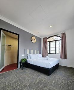 a bedroom with a large bed and a large window at Luna Hotel by Moonknight in George Town