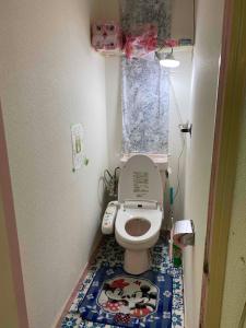 a small bathroom with a toilet with a cow rug at Mason1, Direct to Narita,Haneda AirPort, Disney,Asakusa,Skytree Tower,Tokyo,Ginza All Direct, D in Kamagaya