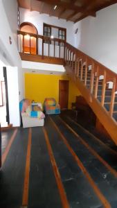 a room with two beds and a stair case at El Fortin in Mar del Plata