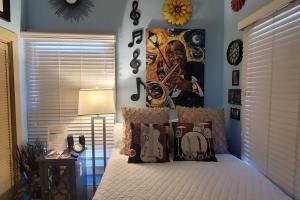 a bedroom with a bed with a poster of a musician at Jazzy Studio in a GREAT Location in New Orleans