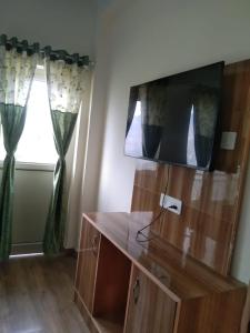 a living room with a tv and a window at Haridwar and kedarnath dharmshala in Haridwār