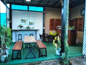 a patio with a table and chairs and a table at ภูคาวิว โฮมสเตย์ in Ban Siri Mun