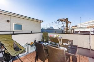 a balcony with a table and chairs on a ship at エクセルシア in Osaka