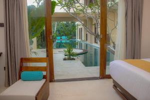 a bedroom with a bed and a view of a pool at Spicepeek Boutique Hotel CMB Airport in Katunayake