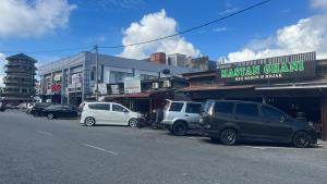 a group of cars parked on the side of a street at Nuha's Homestay Teluk Intan in Teluk Intan