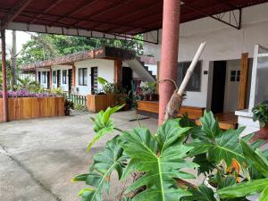 a house with a porch with a plant at Jancas Vacation Home Camiguin Family Room in Catarman