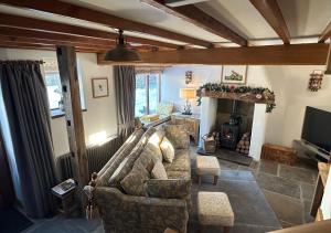 salon z kanapą i kominkiem w obiekcie Red Squirrel Cottage w mieście Hawes