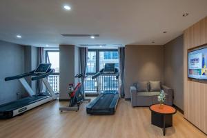 a living room with a gym with two treadmills at Park Inn by Radisson Chongqing Yuelai International Expo Center in Chongqing