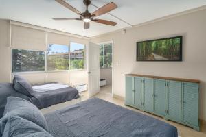 a bedroom with two beds and a ceiling fan at A-312 Haleakala Shores in Wailea +17 photos