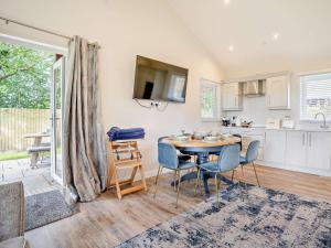 a kitchen and dining room with a table and chairs at 2 Bed in Gower 91728 