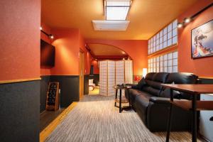 a living room with a couch and a table at ゼロイン祇園三条 in Kyoto