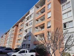 un edificio de apartamentos con coches estacionados frente a él en Departamente 2 habitaciones 2 baños a pasos playas supermercado y plaza de armas, en La Serena