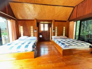 Postel nebo postele na pokoji v ubytování Pai Kiniman Resort