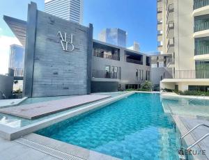 a swimming pool in front of a building at Convenient 1BR at Ahad Residences Business Bay by Deluxe Holiday Homes in Dubai