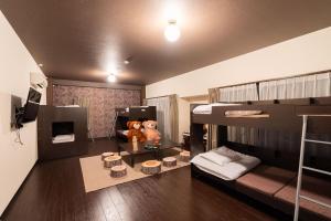 a room with two bunk beds and two teddy bears at Hotel Bokaiso in Takamatsu