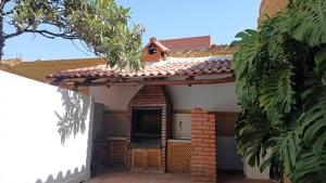 a roof of a house with a man on top at Céntrico Monoambiente con Parrillero Privado in Tarija