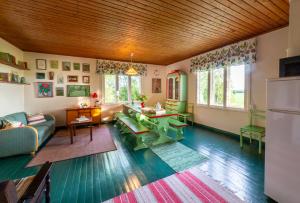 a living room with a couch and a table at Grannys cottage in Laihia