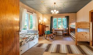 a bedroom with a bunk bed and a dining room at Grannys cottage in Laihia