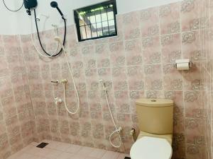 a bathroom with a toilet and a shower in it at Sri Mali Holiday Home in Pelena +28 photos
