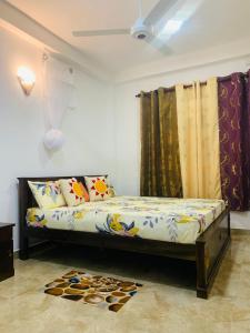 a bed in a room with curtains and a rug at Sri Mali Holiday Home in Pelena
