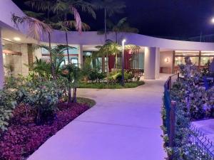 a walkway in front of a building at night at Mana beach class experience in Porto De Galinhas