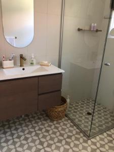 a bathroom with a sink and a shower with a mirror at MRS BROWN’s COMFY CITY PAD in Norwood