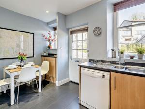 a kitchen with a table and a dining room at 3 Bed in Kendal 91839 in Kendal