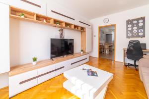 a living room with a large flat screen tv at ""Comfort 14'' in Miskolc