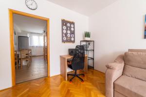 a living room with a couch and a chair and a table at ""Comfort 14'' in Miskolc