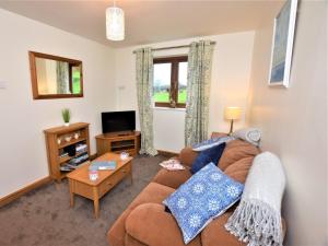a living room with a couch and a tv at 1 Bed in Liskeard 85888 in Saint Neot